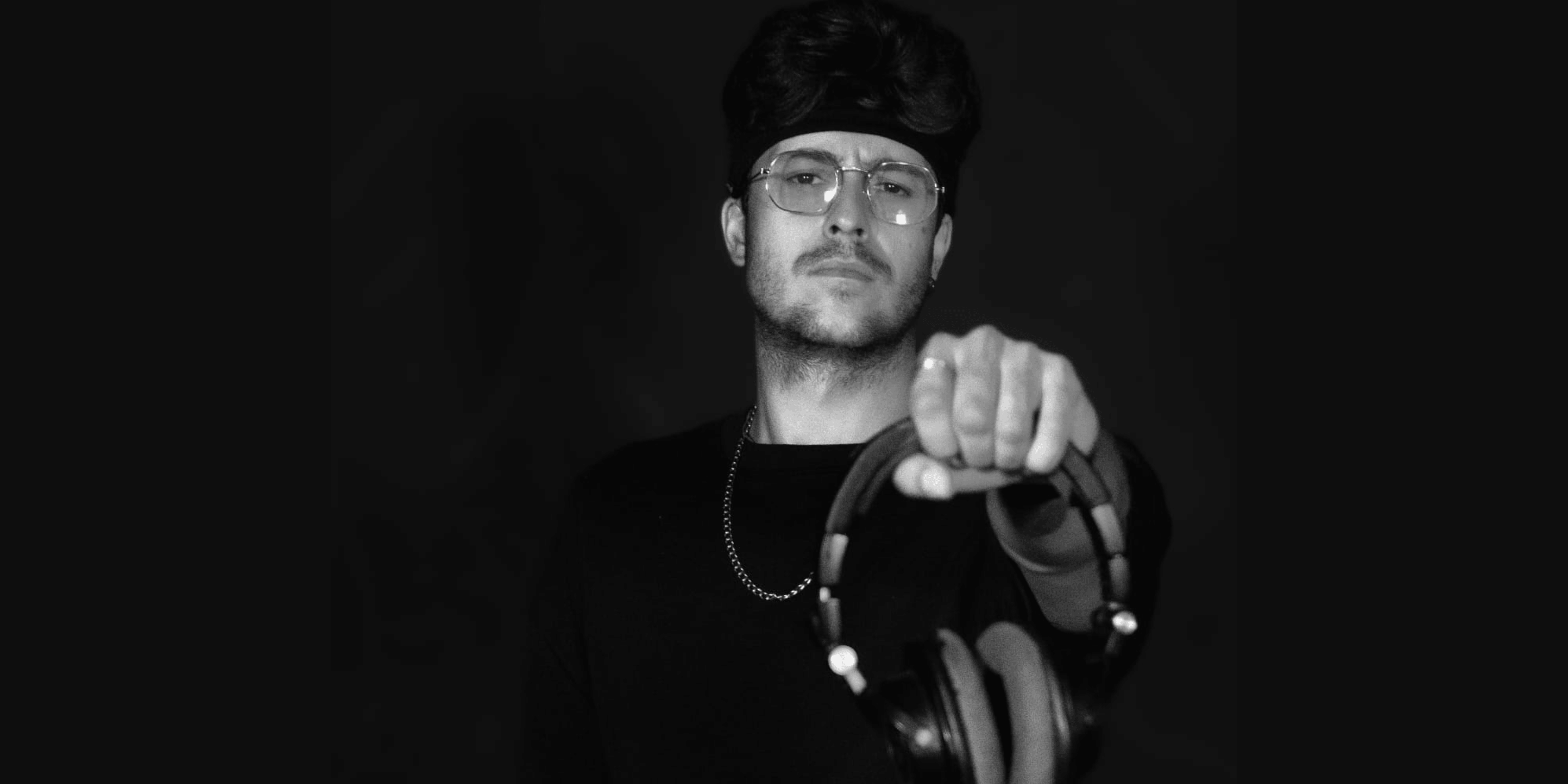 PICAZZO photographed in black and white, headphones in hand