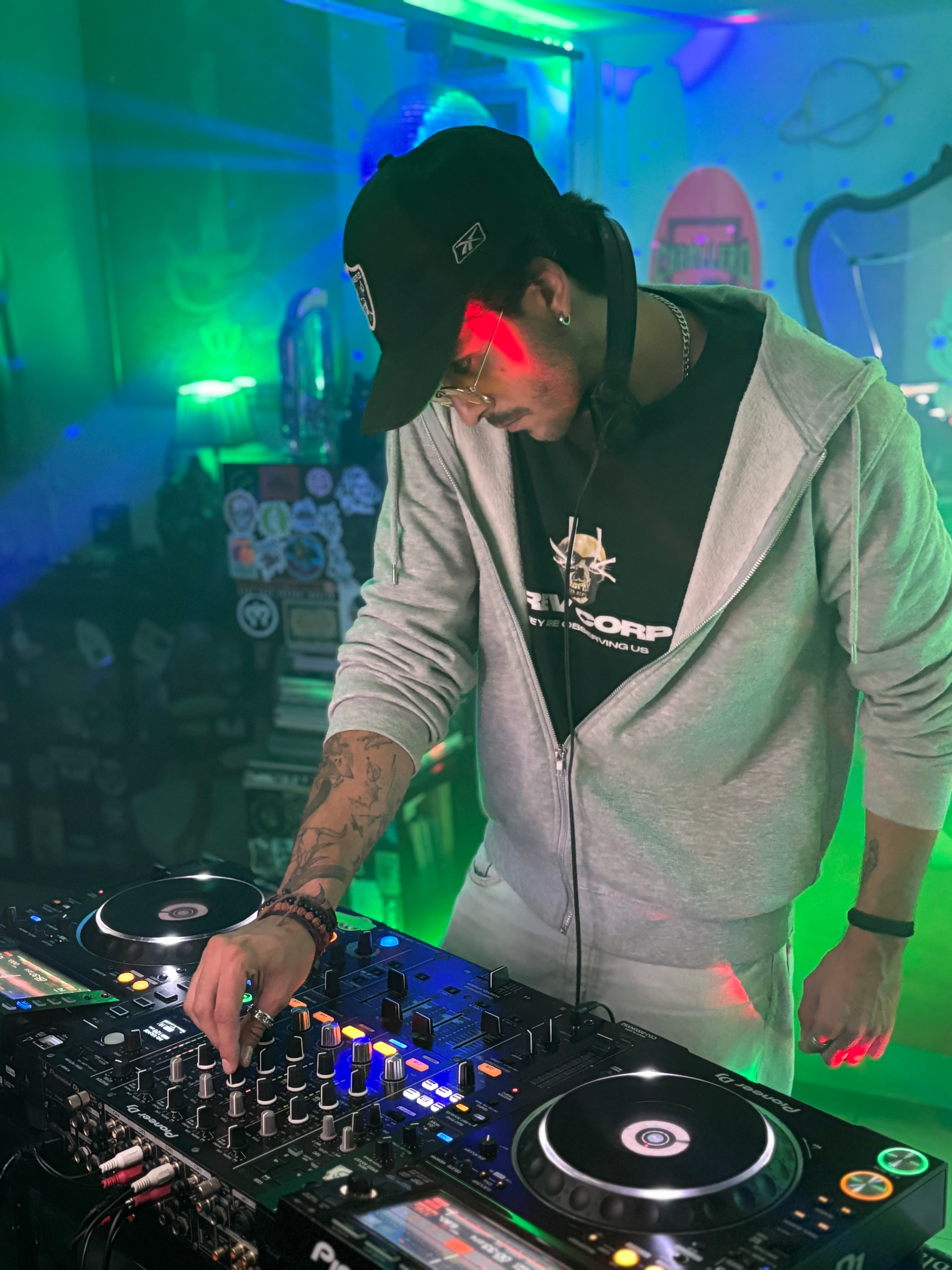 PICAZZO performing behind the decks under green stage light